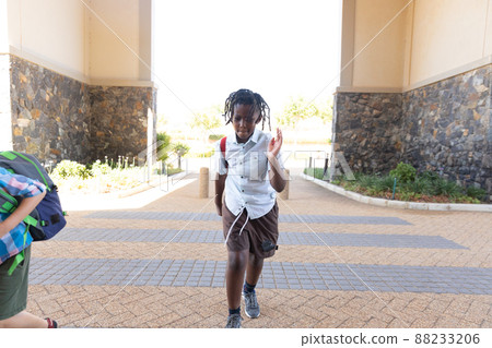 African american elementary schoolboy running for school 88233206