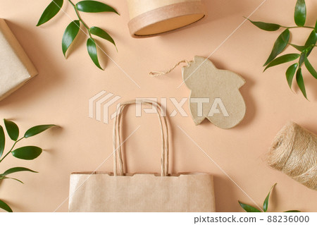 A frame made of paper and leaf packaging on a beige background. Takeaway food delivery. Eco-packaging. Zero waste. 88236000