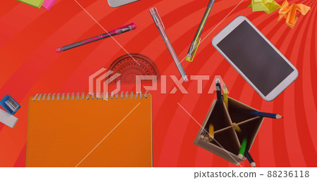 Image of laptop and office items over orange spinning stripes Image of laptop and office items over orange spinning stripes 88236118