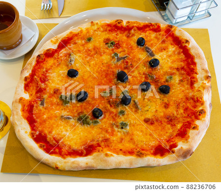 Appetizing Roman pizza with olives on table Appetizing Roman pizza with olives on table 88236706
