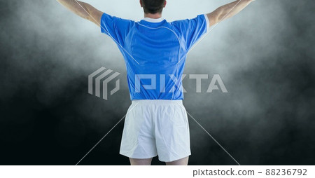 Rear view of male athlete celebrating against copy space on grey background Rear view of male athlete celebrating against copy space on grey background 88236792