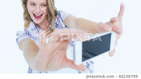 Caucasian woman taking a selfie from her smartphone against copy space on white background Caucasian woman taking a selfie from her smartphone against copy space on white background 88236799
