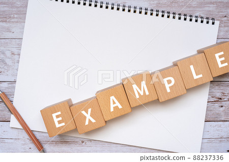 Building blocks, notebooks and pens with "EXAMPLE" written on them 88237336
