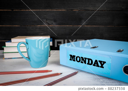 Monday. Document folder and office supplies on a wooden table 88237338