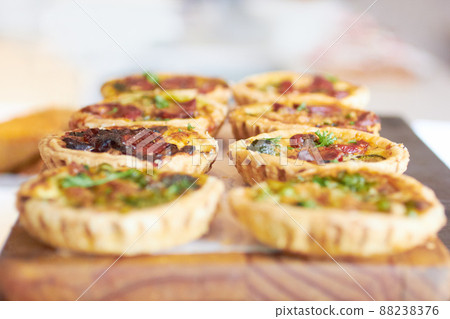 Mini quiches are the perfect snack. Cropped shot of a fresh batch of mini quiches. 88238376
