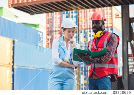 The Problem with businesswoman and engineer talking and checking loading Containers box from Cargo freight ship for import export. shipping in docks. The Problem with businesswoman and engineer talking and checking loading Containers box from Cargo freight ship for import export. shipping in docks. 88238639