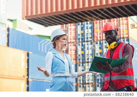 The Problem with businesswoman and engineer talking and checking loading Containers box from Cargo freight ship for import export. shipping in docks. The Problem with businesswoman and engineer talking and checking loading Containers box from Cargo freight ship for import export. shipping in docks. 88238640