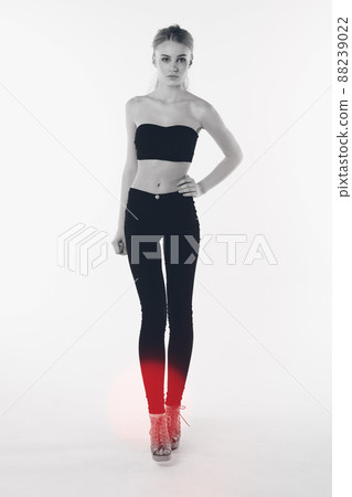 Shes an IT girl. Full length shot of a gorgeous young woman standing in the studio. 88239022