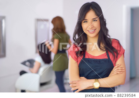 Ill style you right. Cropped shot of an attractive young woman in the hair salon. 88239584