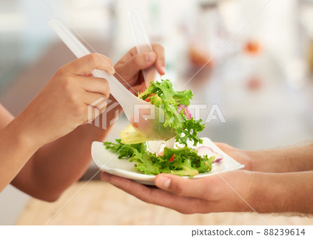 Keeping it healthy. Closeup of a healthy green salad being served. 88239614