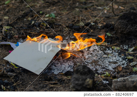Burning in the fire of a torn notebook. The cover and the multi-colored sheets burn into gray ash. Burning in the fire of a torn notebook. The cover and the multi-colored sheets burn into gray ash. 88240697