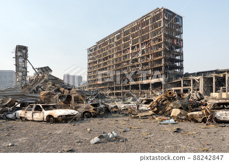 Russia war damage building destruction city war ruins city damage car. Terror attack bomb shell of civilian bombed. Disaster area. 2022 Russian invasion of Ukraine war torn city destroyed car burn out 88242847