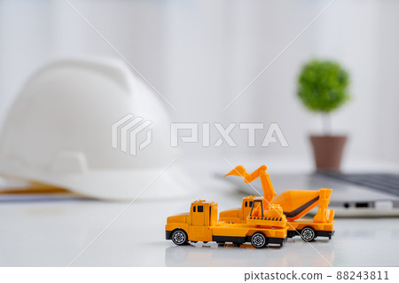 Concrete mixer truck and excavator on architect's desk, Engineering objects, Construction site. 88243811