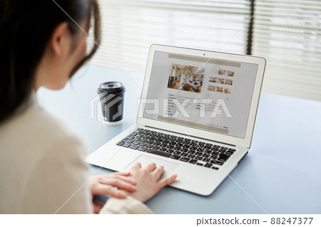 亞洲女性在電腦上查看房地產網站 亞洲女性在電腦上查看房地產網站 88247377