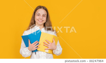 knowledge day. kid hold notebook. student in high school. teen girl do homework 88247964