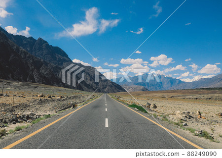 Asphalt Road in the High Gilgit Baltistan Mountains under the Blue Clouds, Pakistan 88249090