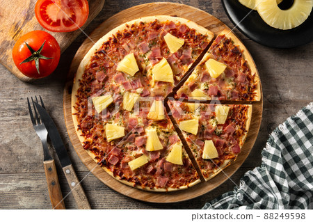Hawaiian pizza with pineapple,ham and cheese on wooden table	 88249598