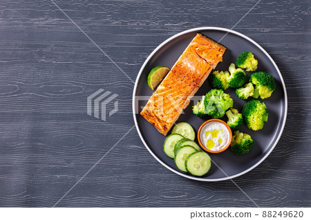 roast salmon fillet with boiled broccoli and sauce 88249620