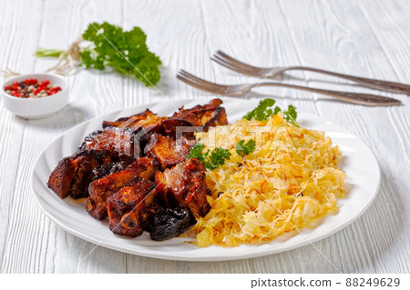 braised sauerkraut with pork and prunes on plate braised sauerkraut with pork and prunes on plate 88249629