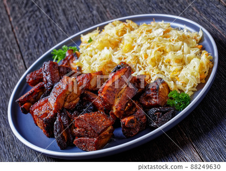 braised sauerkraut with pork and prunes on plate braised sauerkraut with pork and prunes on plate 88249630