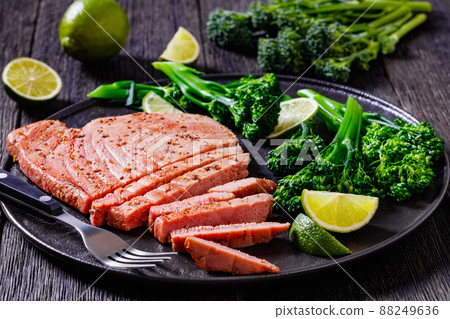 fried tuna steak with boiled broccolini and lime 88249636