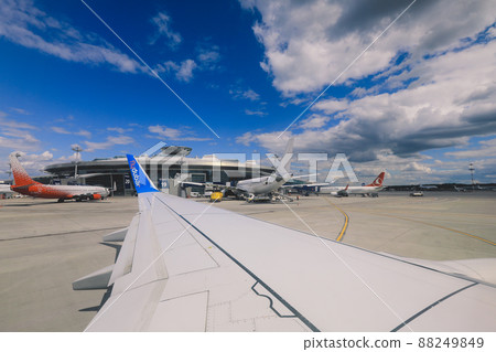 Window View to the Aircraft Wing and Cloudy Blue Sky 88249849