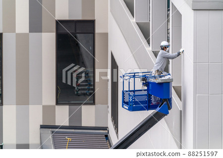 Construction site, aerial work platform, sealing work, caulking Construction site, aerial work platform, sealing work, caulking 88251597