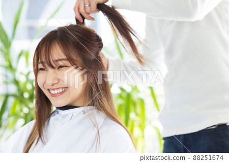 A woman who has her hair set at a beauty salon A woman who has her hair set at a beauty salon 88251674