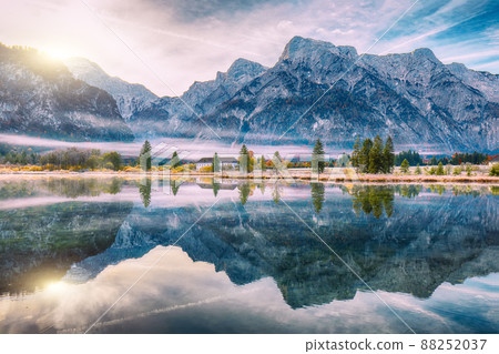 Spectacular autumn scene of foggy and sunny morning on Almsee lake. Spectacular autumn scene of foggy and sunny morning on Almsee lake. 88252037
