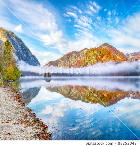 Outstanding autumn scene of foggy and sunny morning on Almsee lake 88252042