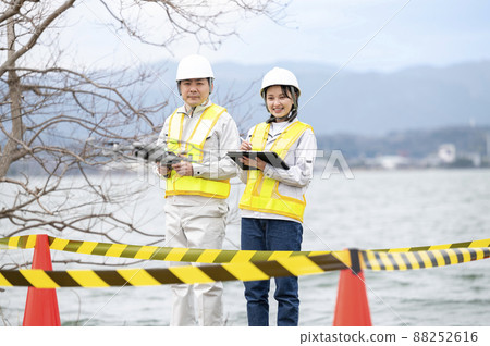 Worker operating a drone, taken in March 2022 in Shiga Prefecture 88252616
