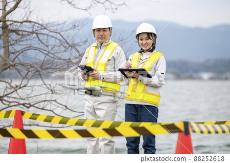 Worker operating a drone, taken in March 2022 in Shiga Prefecture 88252618