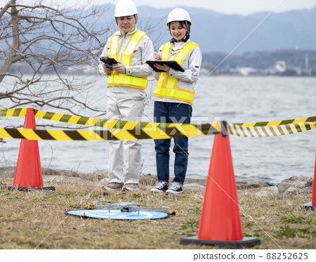 Worker operating a drone, taken in March 2022 in Shiga Prefecture 88252625