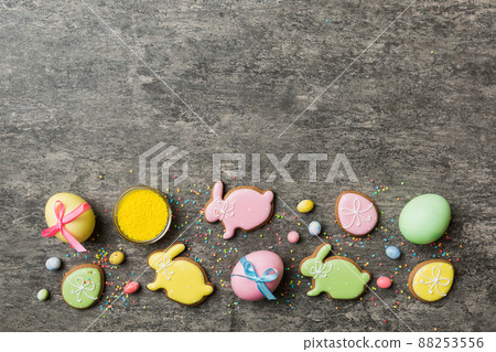 holiday preparation Multi colors Easter eggs with cookies on colored background . Pastel color Easter eggs. holiday concept with copy space holiday preparation Multi colors Easter eggs with cookies on colored background . Pastel color Easter eggs. holiday concept with copy space 88253556