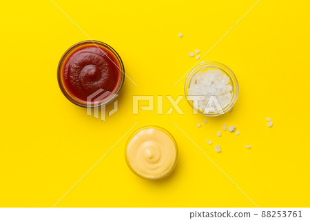 Bowl of salt, ketchup and cheese sauce on colored background, top view with copy space Bowl of salt, ketchup and cheese sauce on colored background, top view with copy space 88253761