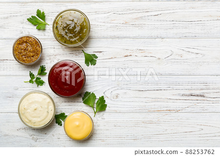 Many different sauces and herbs on table, flat lay top view. sauces with spices healthy concept Many different sauces and herbs on table, flat lay top view. sauces with spices healthy concept 88253762