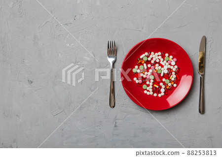 Many different weight loss pills and supplements as food on round plate. Pills served as a healthy meal. Drugs, pharmacy, medicine or medical healthycare concept Many different weight loss pills and supplements as food on round plate. Pills served as a healthy meal. Drugs, pharmacy, medicine or medical healthycare concept 88253813