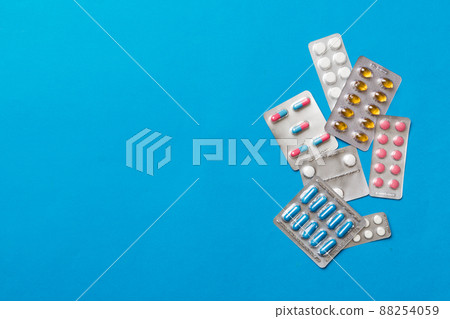 Protective face masks or surgical masks, medicine pills and thermometer on table background. Coronavirus disease. Corona virus concept. Space for text 88254059