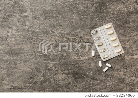 Protective face masks or surgical masks, medicine pills and thermometer on table background. Coronavirus disease. Corona virus concept. Space for text 88254060