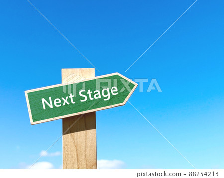 Next Stage text green signpost and blue sky_right space 88254213