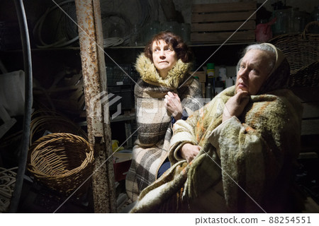 Frightened women hide from explosions in the basement. During the sirens due to the shelling of Kyiv. Ukraine Frightened women hide from explosions in the basement. During the sirens due to the shelling of Kyiv. Ukraine 88254551