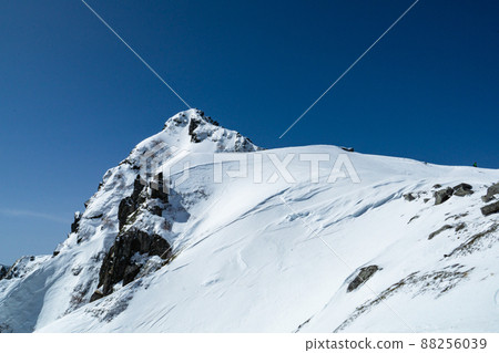 The summit of Mt. Hoken, which was covered with snow in the Central Alps of Nagano Prefecture 88256039