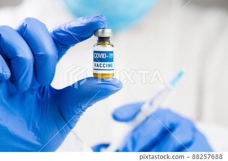 Hands in gloves holding ampoule & syringe jab Hands in gloves holding ampoule & syringe jab 88257688