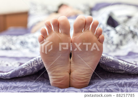 Women's feet close-up. The concept of small size women's shoes Women's feet close-up. The concept of small size women's shoes 88257785