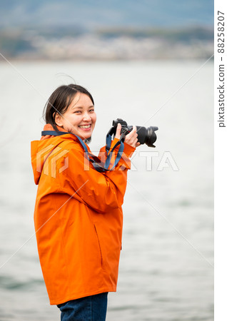 my hobby! A young woman taking a picture by the lake my hobby! A young woman taking a picture by the lake 88258207