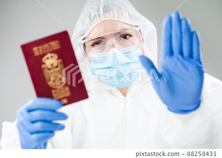 Security officer at airport customs security check holding passport 88258431