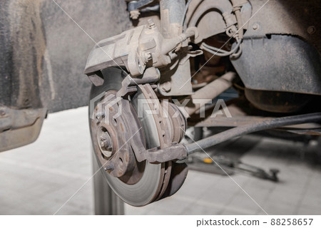Car disc brake and hub without a wheel in the auto repair shop service Car disc brake and hub without a wheel in the auto repair shop service 88258657