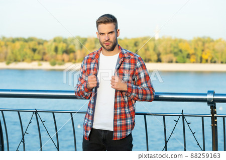 young bearded guy in checkered shirt outdoor, lifestyle 88259163