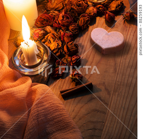 Candles and dried rosebuds on the table Candles and dried rosebuds on the table 88259193