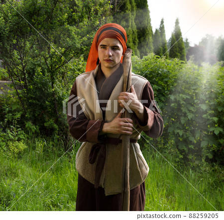Shepherd hold a staff in his arms 88259205